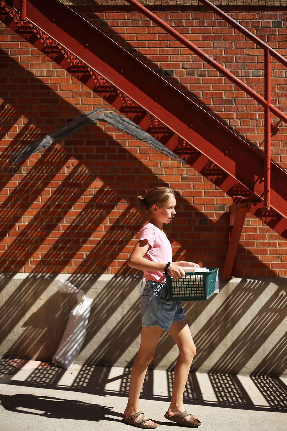 Caroline Crago carries a crate out to the next truck being loaded